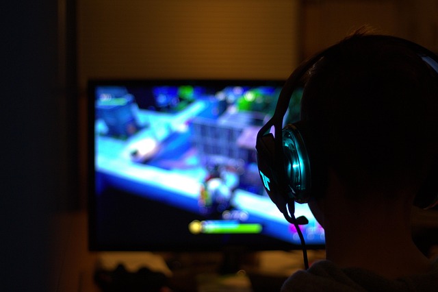 A gaming setup with a large screen displaying a game