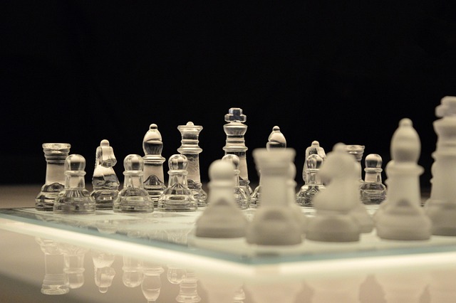 Glass chessboard with chess pieces, representing strategic thinking